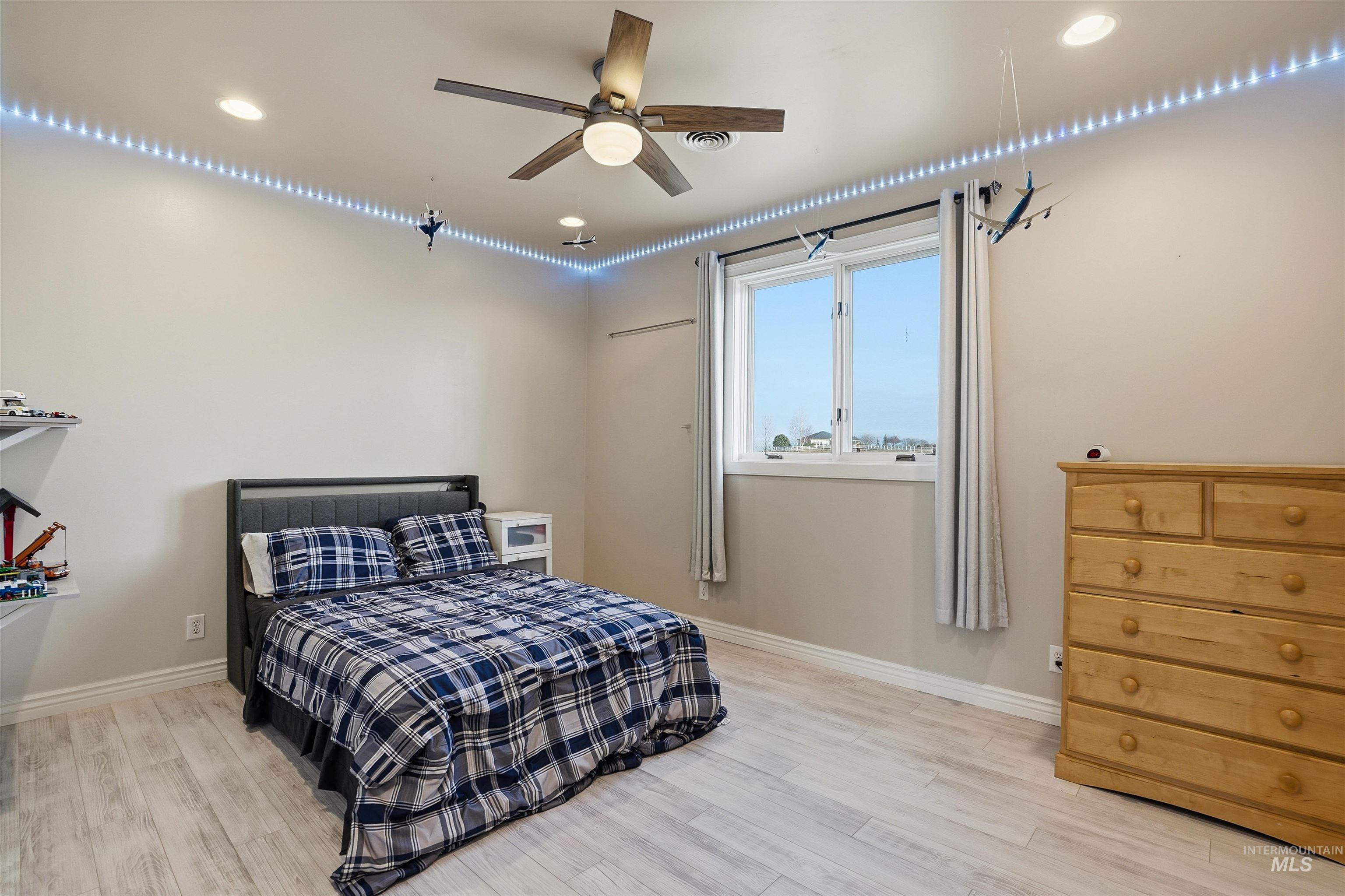 Bedroom featuring light wood-style flooring, recessed lighting, and a ceiling fan