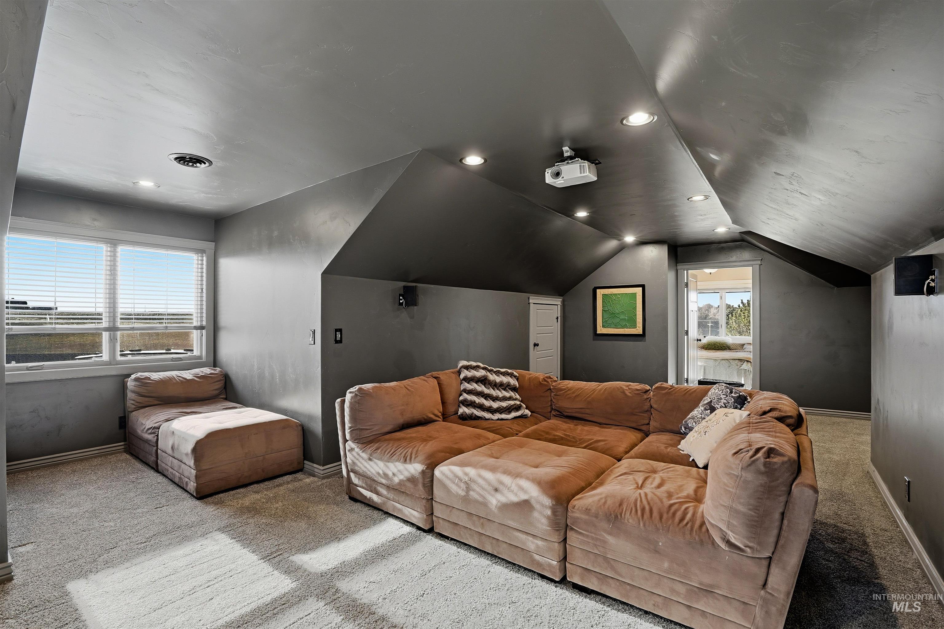 Cinema featuring carpet floors, recessed lighting, and vaulted ceiling