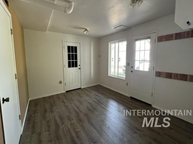 Entryway featuring baseboards and wood finished floors
