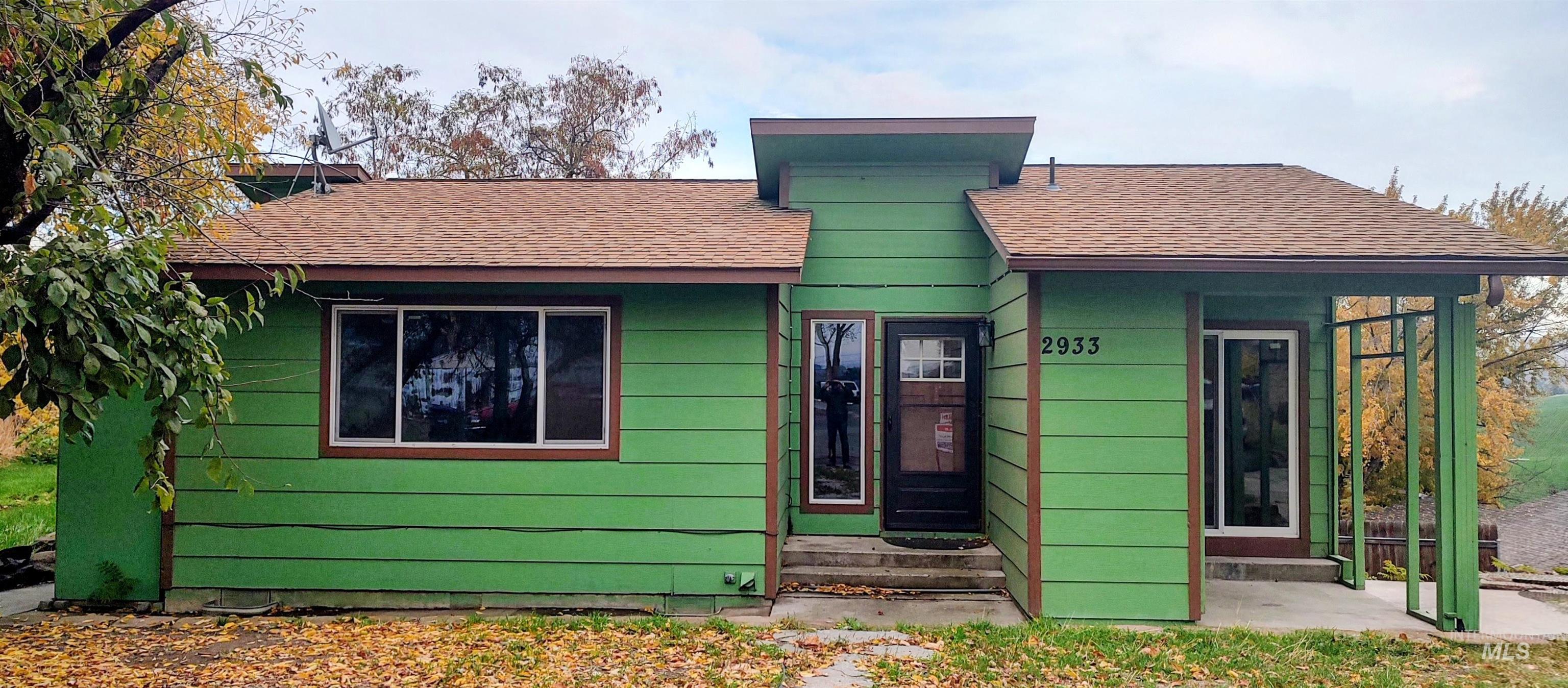 View of front of home featuring a shingled roof and entry steps