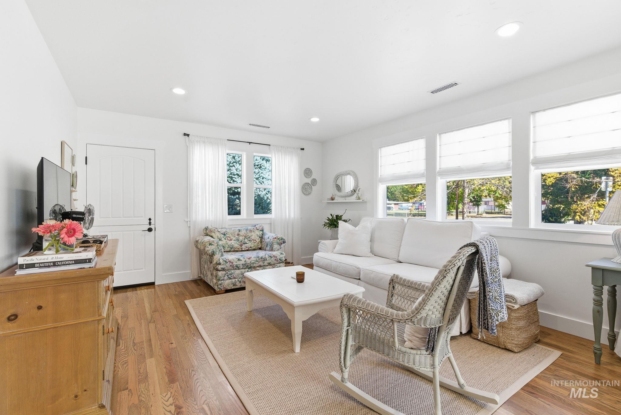 Living area featuring light wood finished floors and recessed lighting