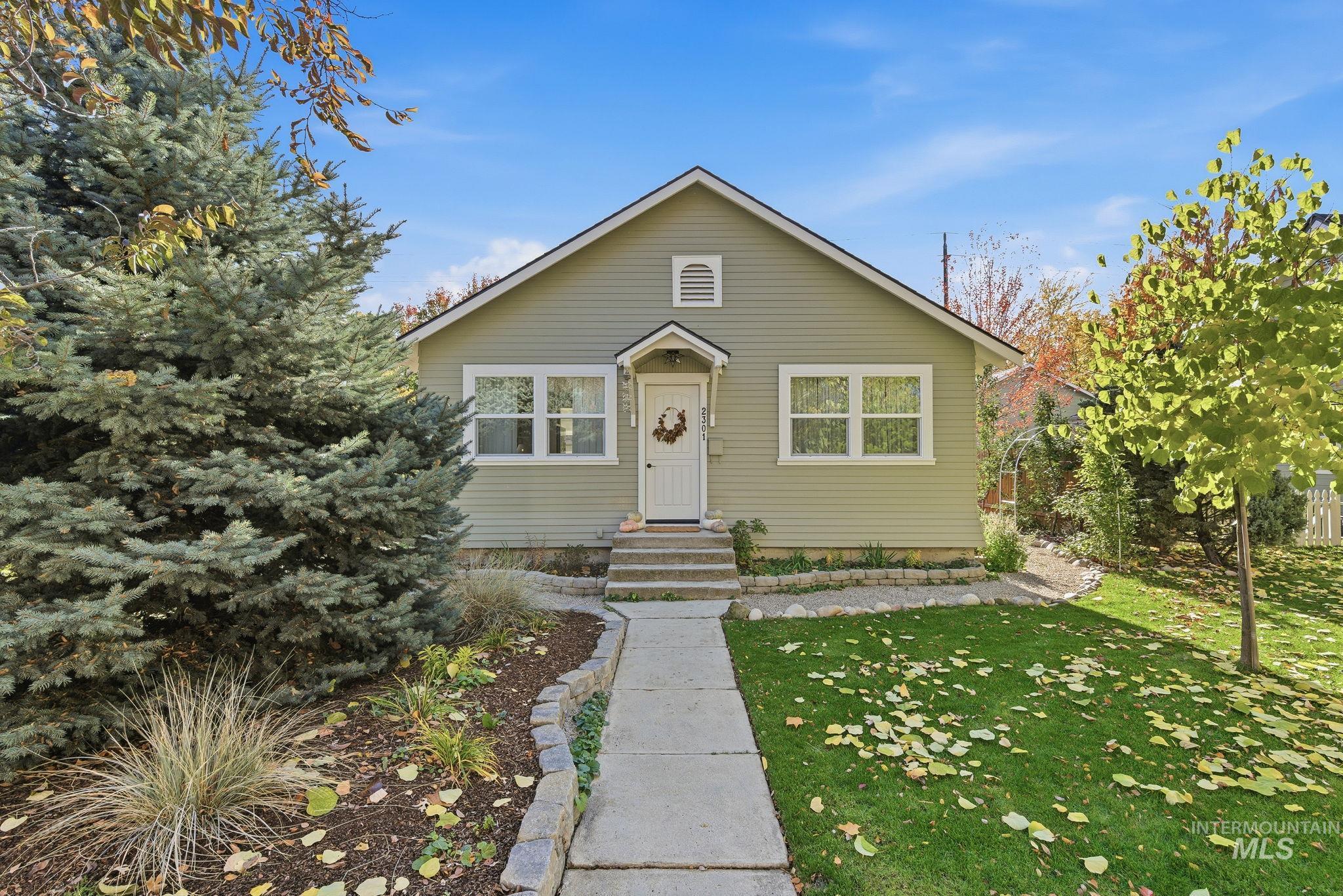 Bungalow-style house featuring a front yard and entry steps
