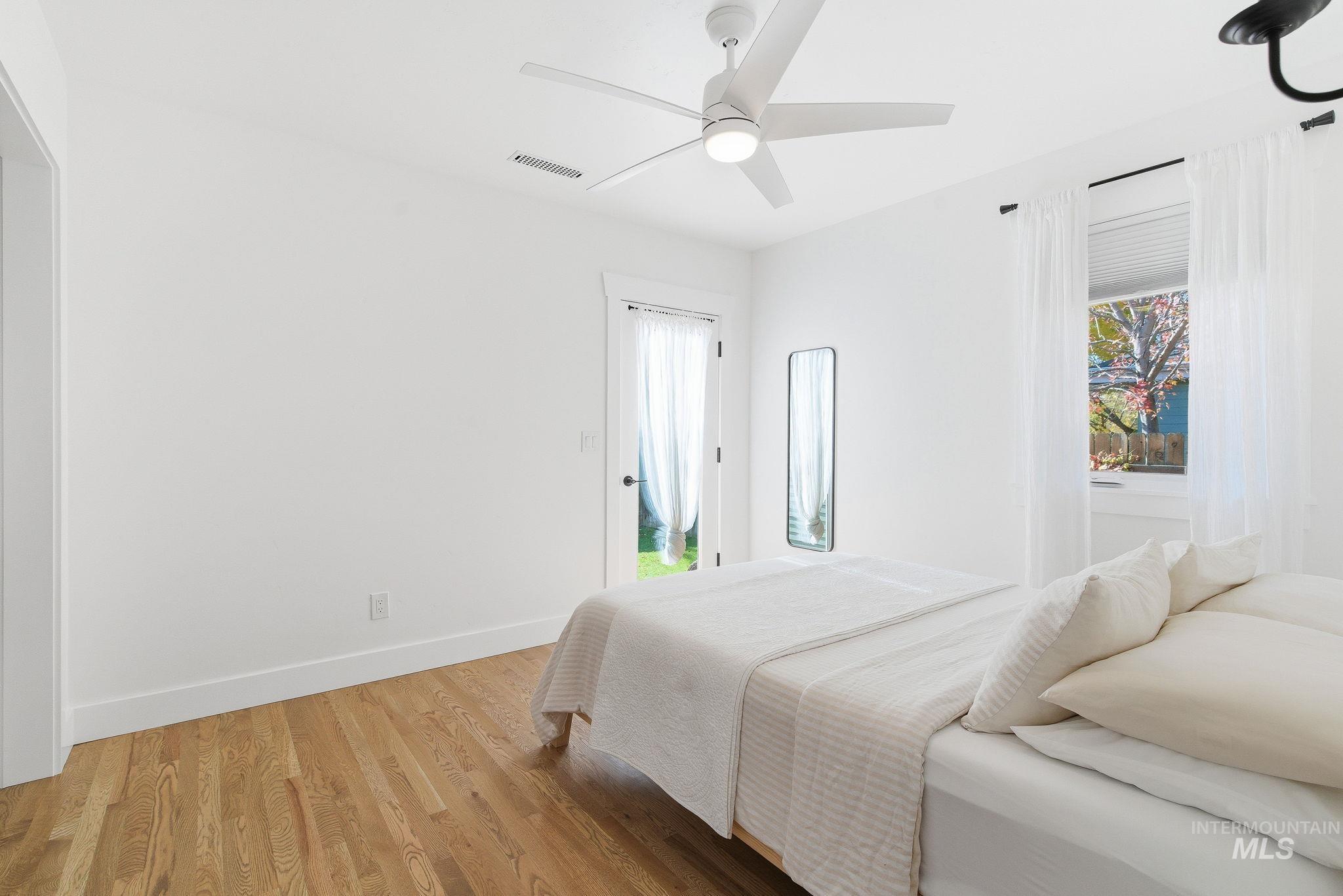 Bedroom featuring wood finished floors and a ceiling fan