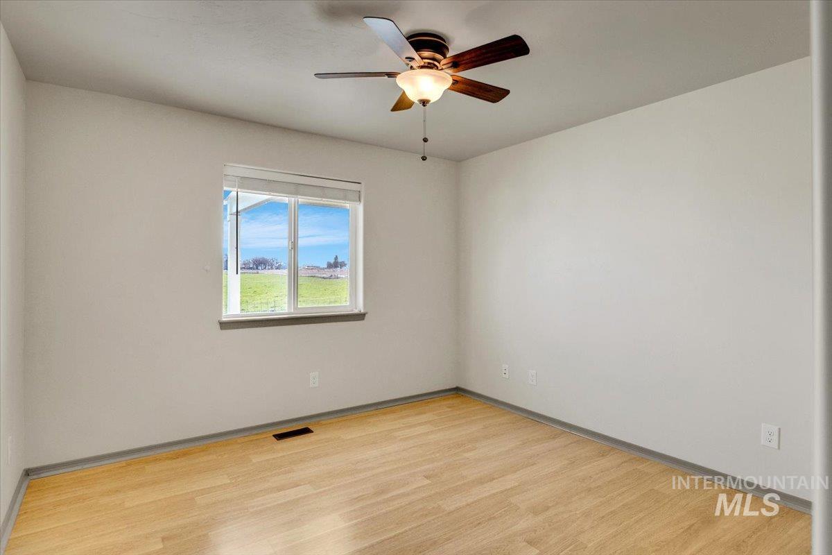 room featuring light wood-style floors and a ceiling fan