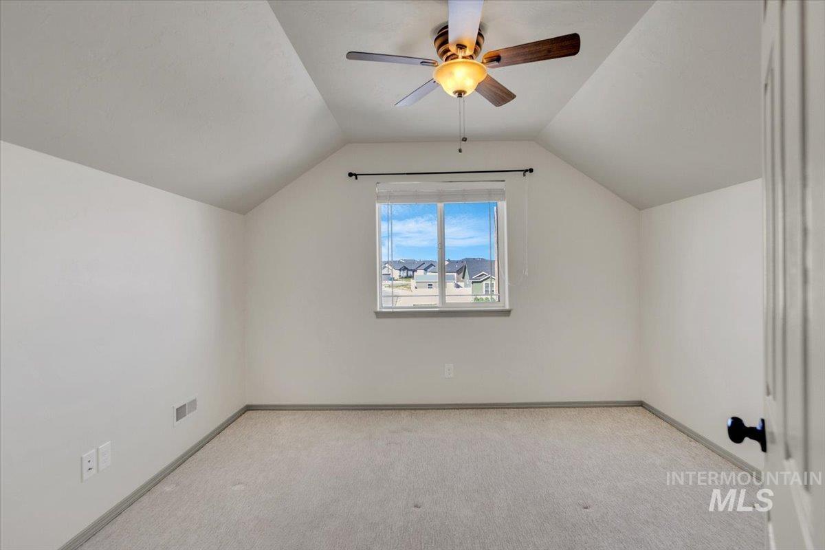 Bedroom with light carpet and ceiling fan