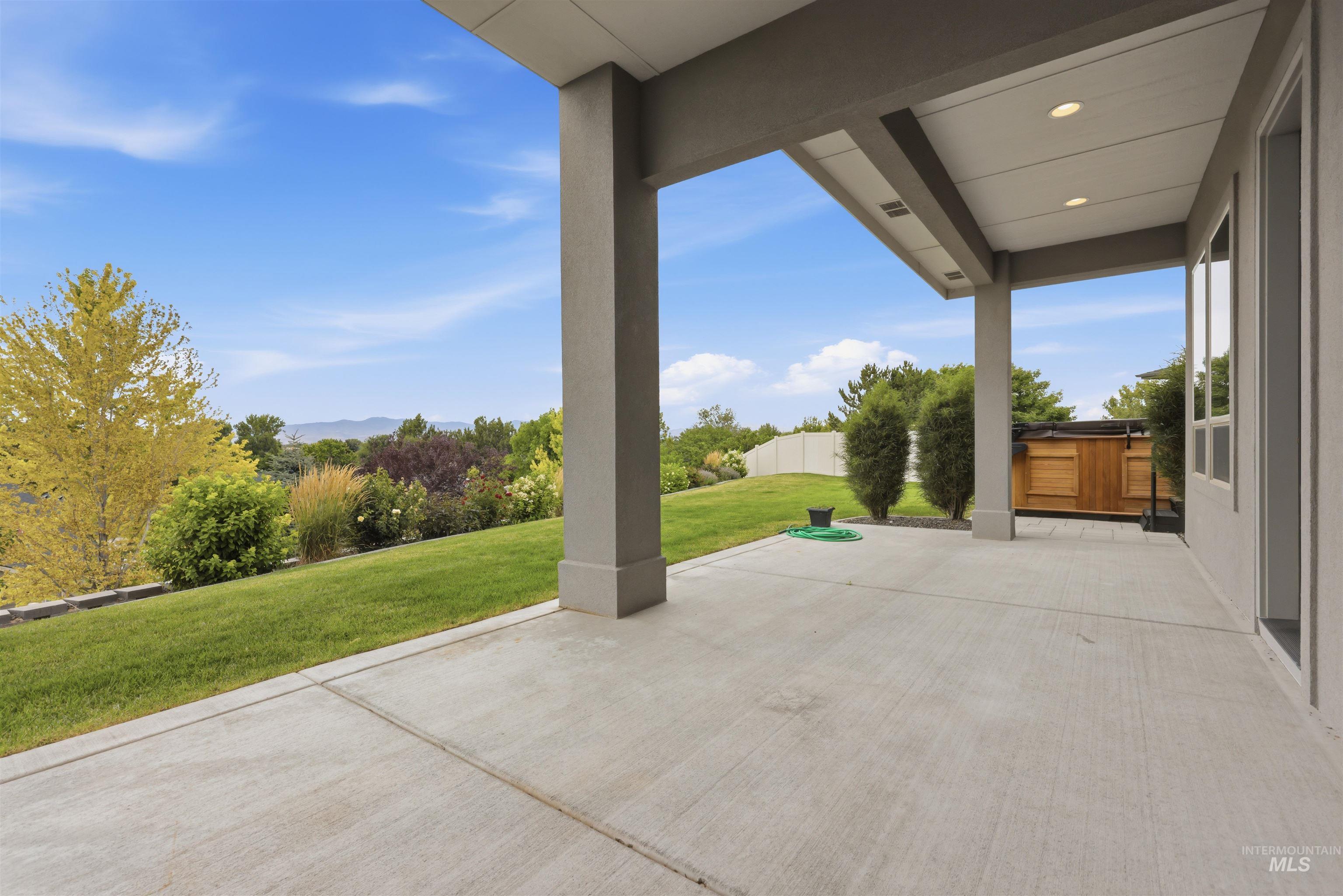Expansive concrete patio offering covered outdoor living