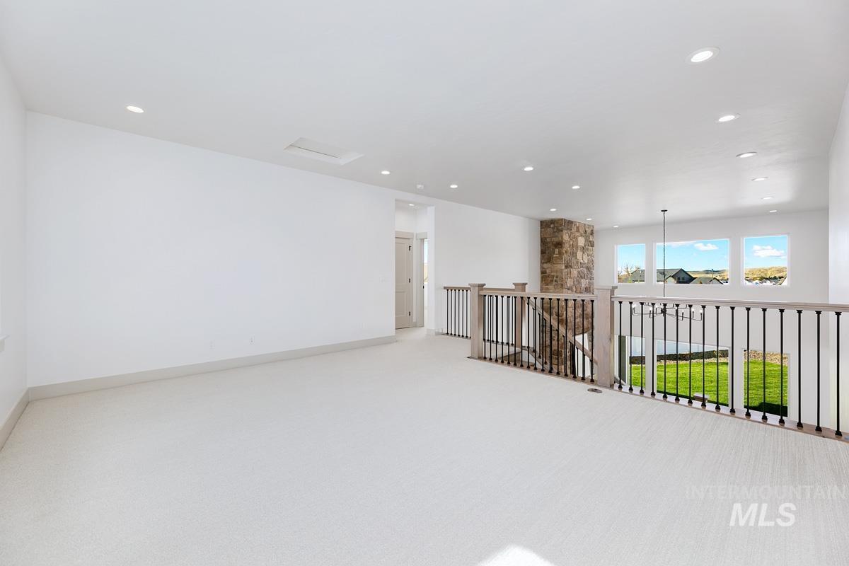 Unfurnished room with light colored carpet and recessed lighting