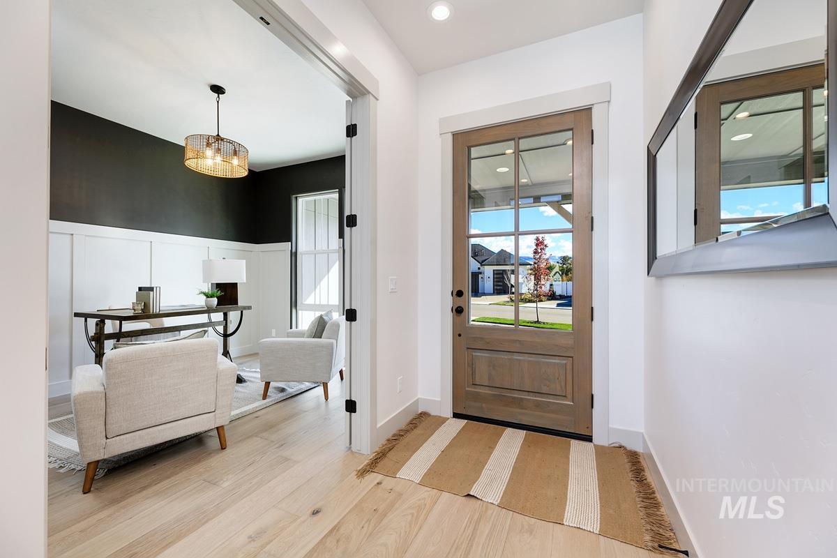 Foyer with light wood-style floors and recessed lighting