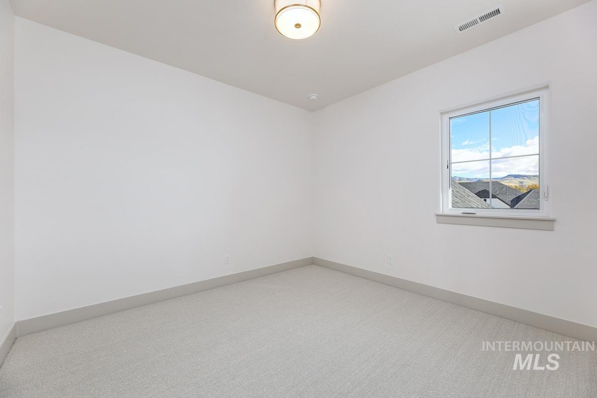 Empty room featuring carpet floors and baseboards