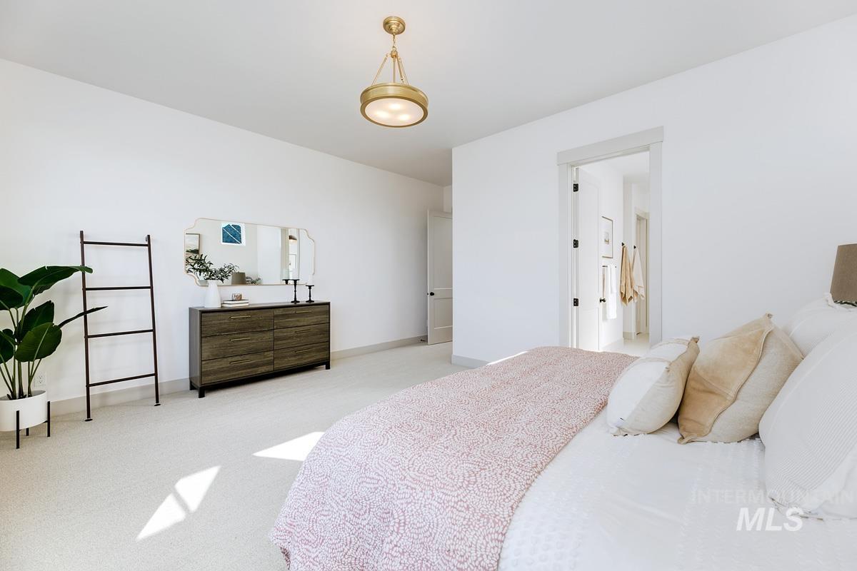 Bedroom featuring carpet flooring and baseboards