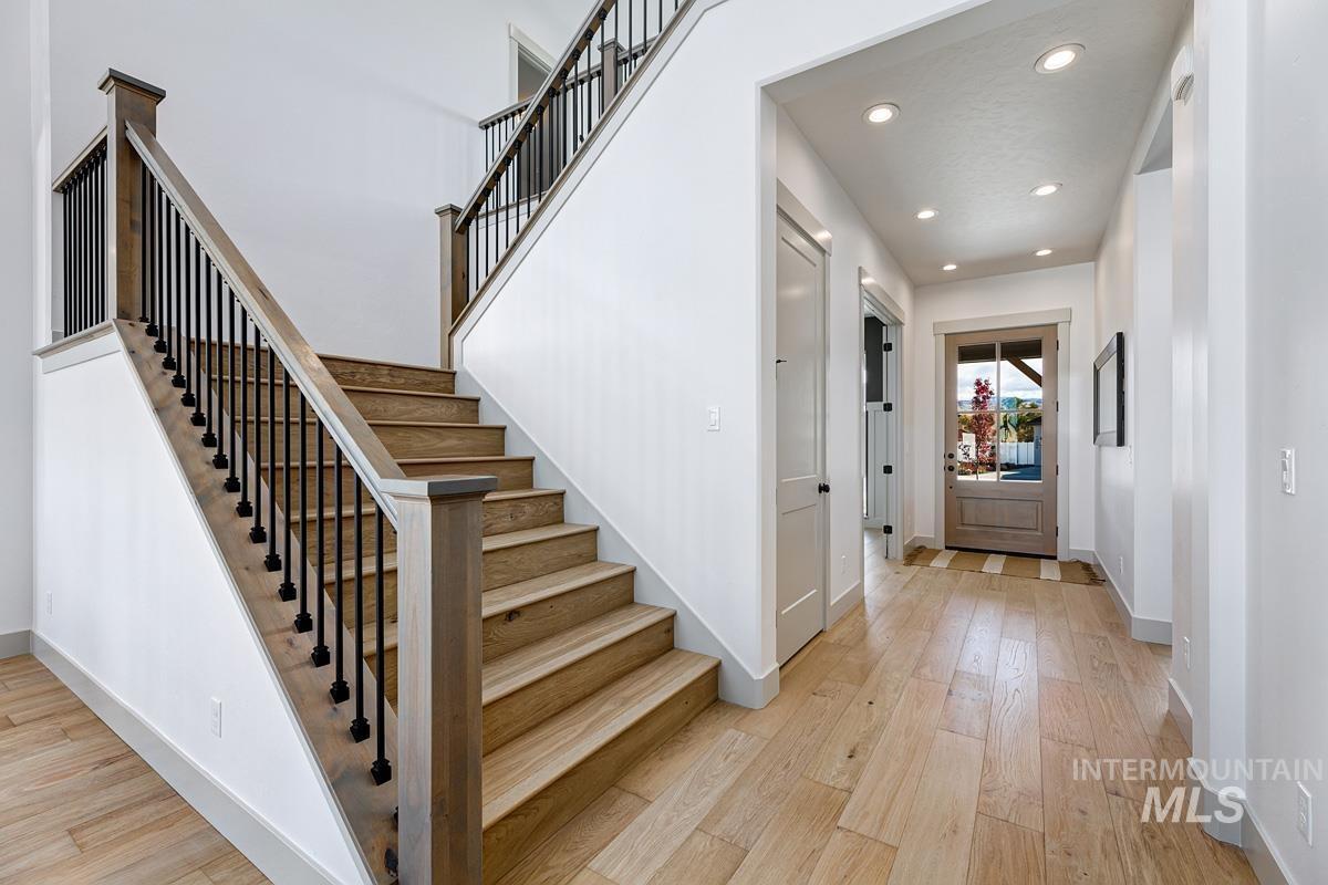 Foyer with light wood-type flooring, recessed lighting, and stairway