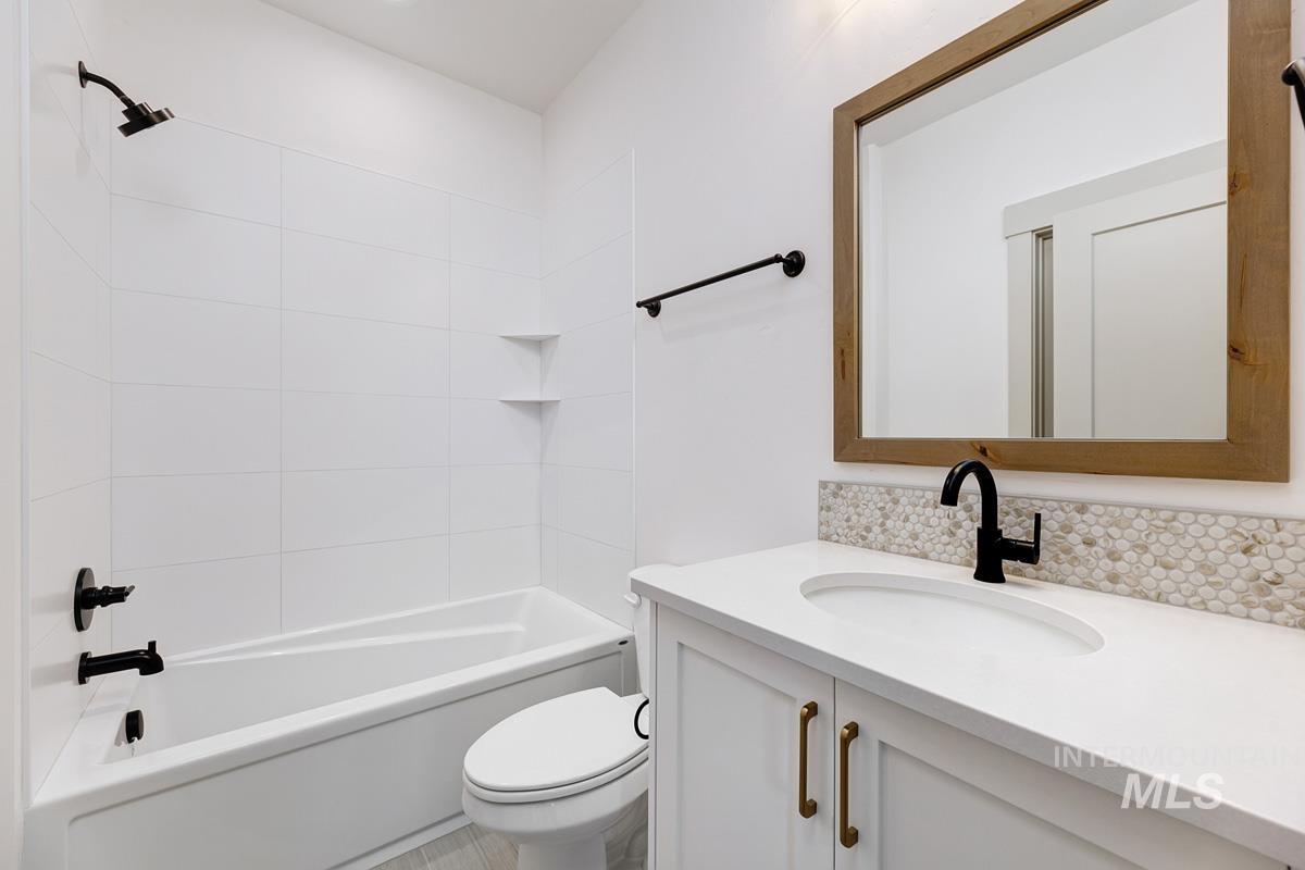 Bathroom with vanity and bathtub / shower combination