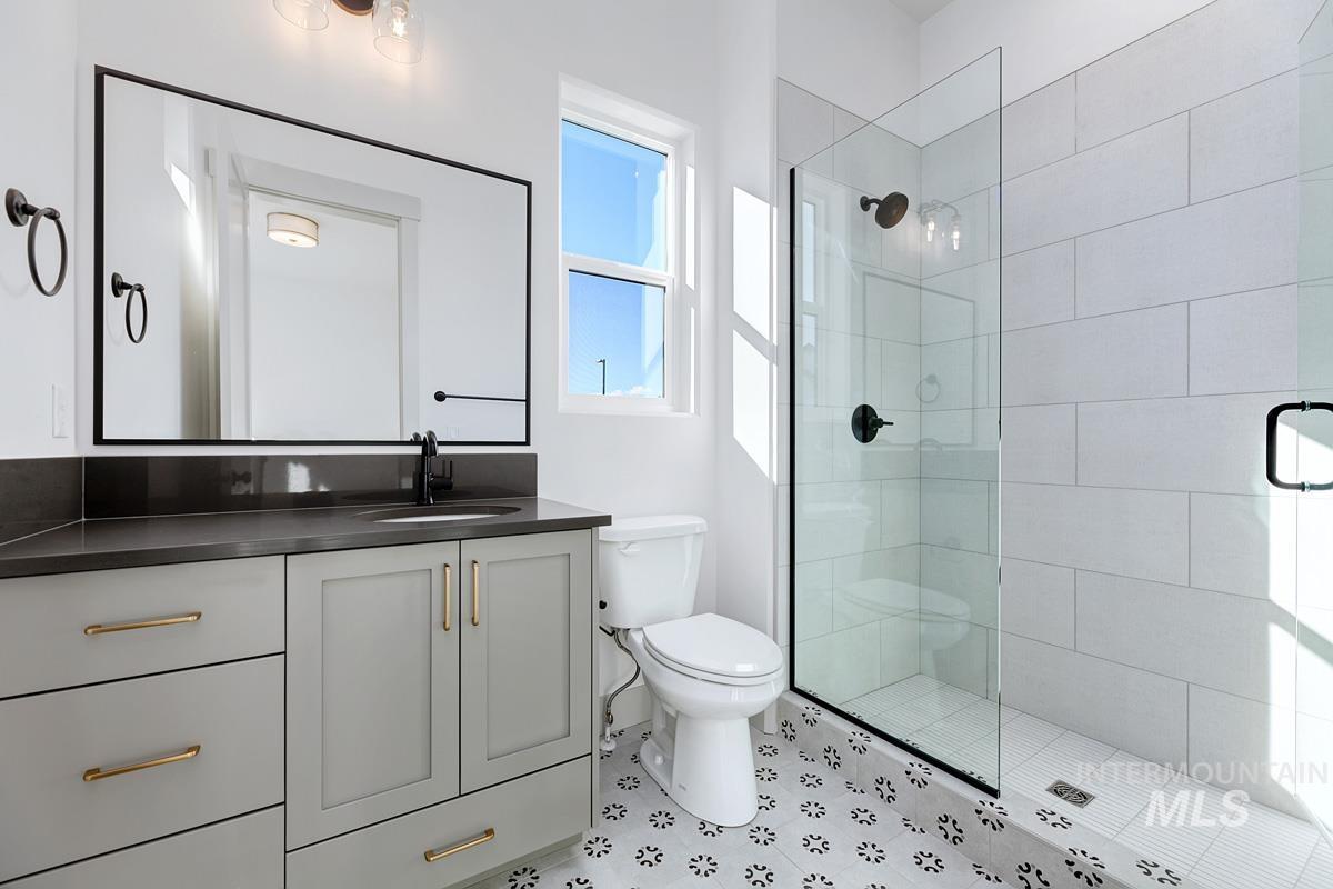 Full bath with vanity and a shower stall