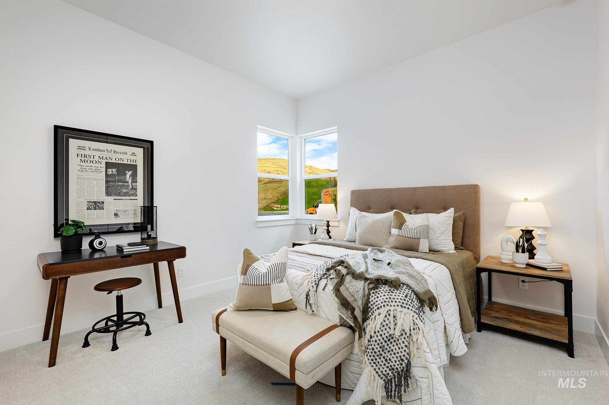 Bedroom featuring light colored carpet