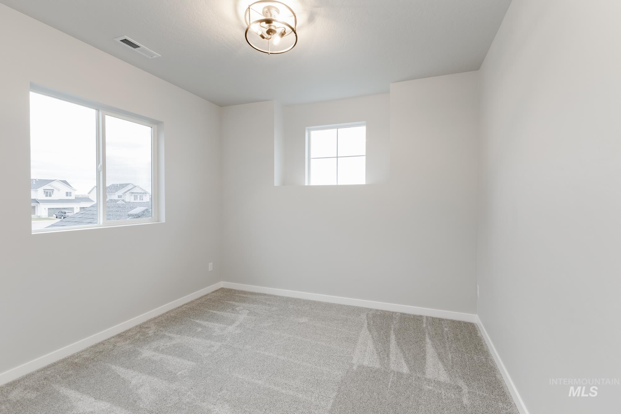 Spare room with carpet flooring and baseboards