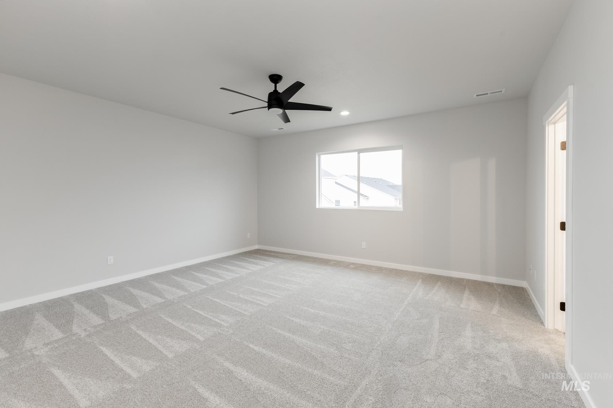 Unfurnished room featuring light colored carpet, recessed lighting, and a ceiling fan