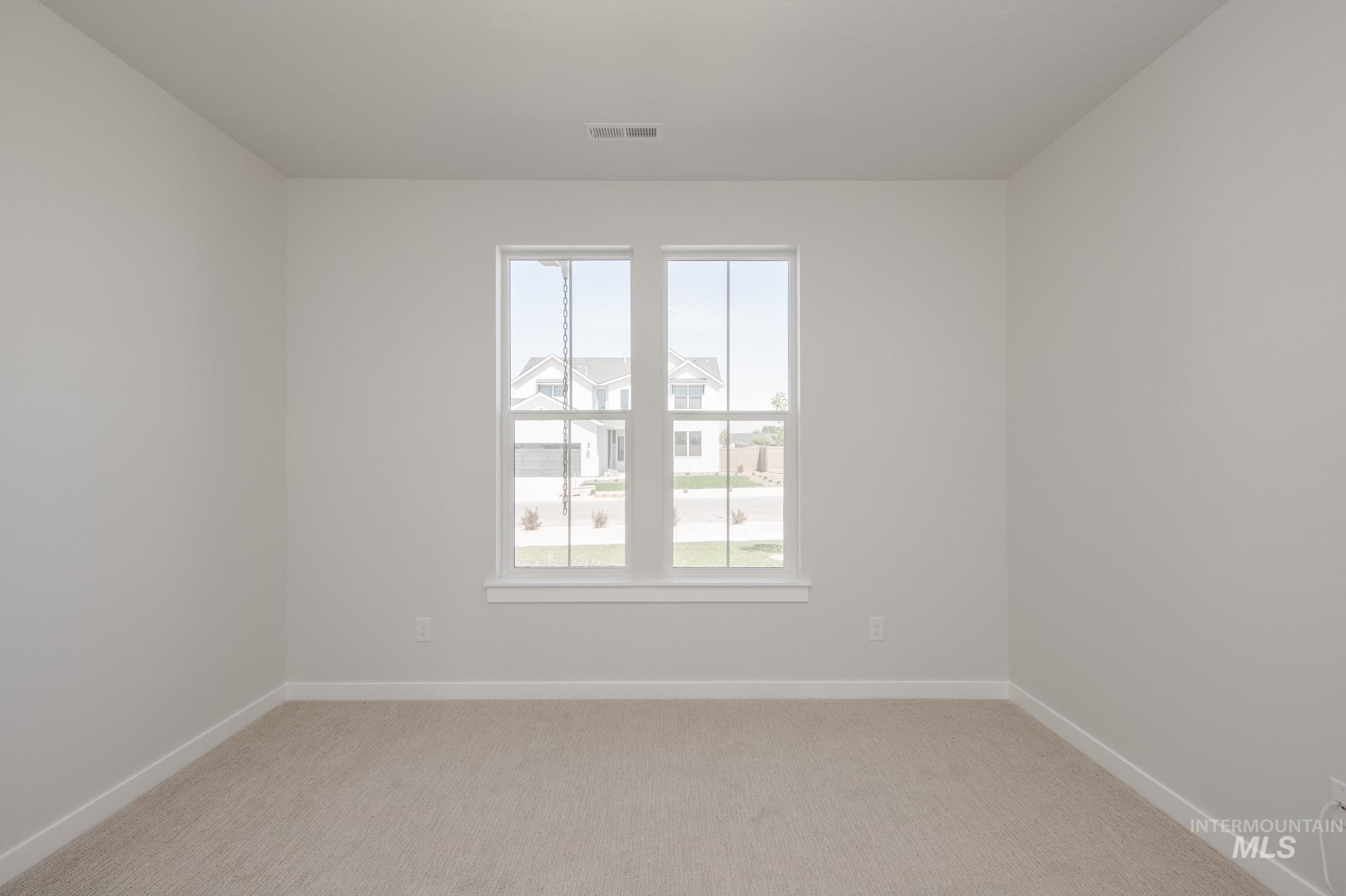 Unfurnished room with light carpet