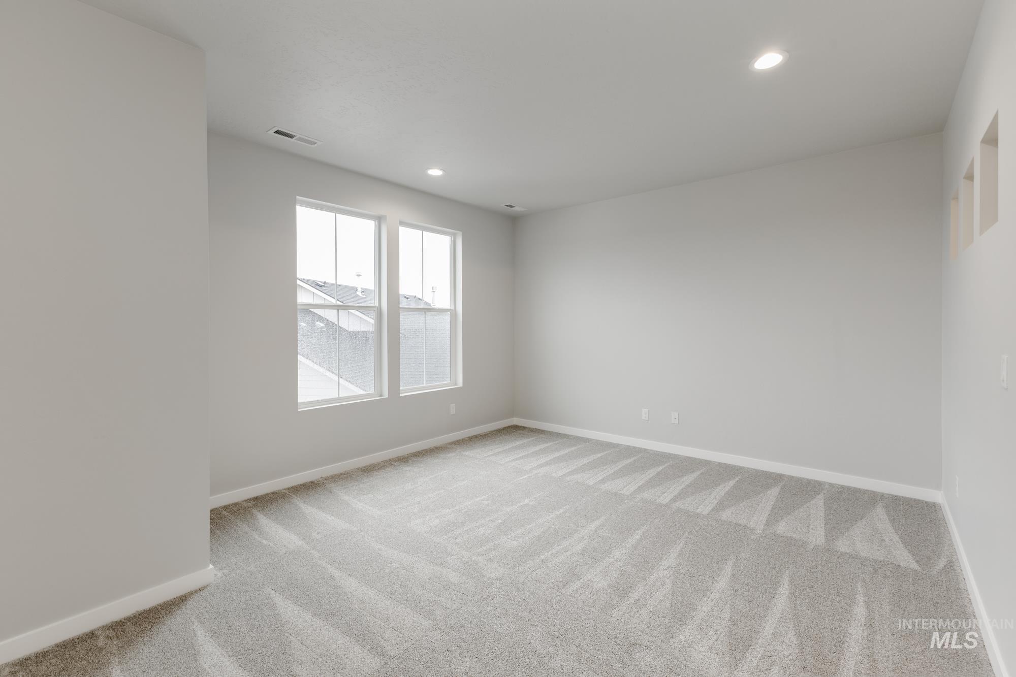 Unfurnished room featuring light carpet and recessed lighting
