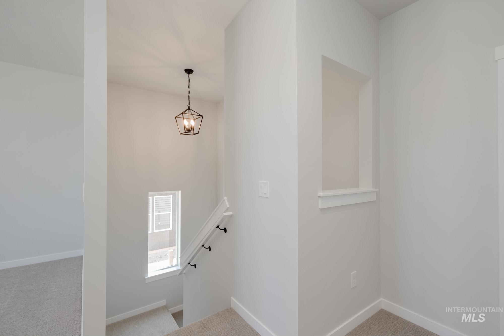 Stairs with carpet flooring and baseboards