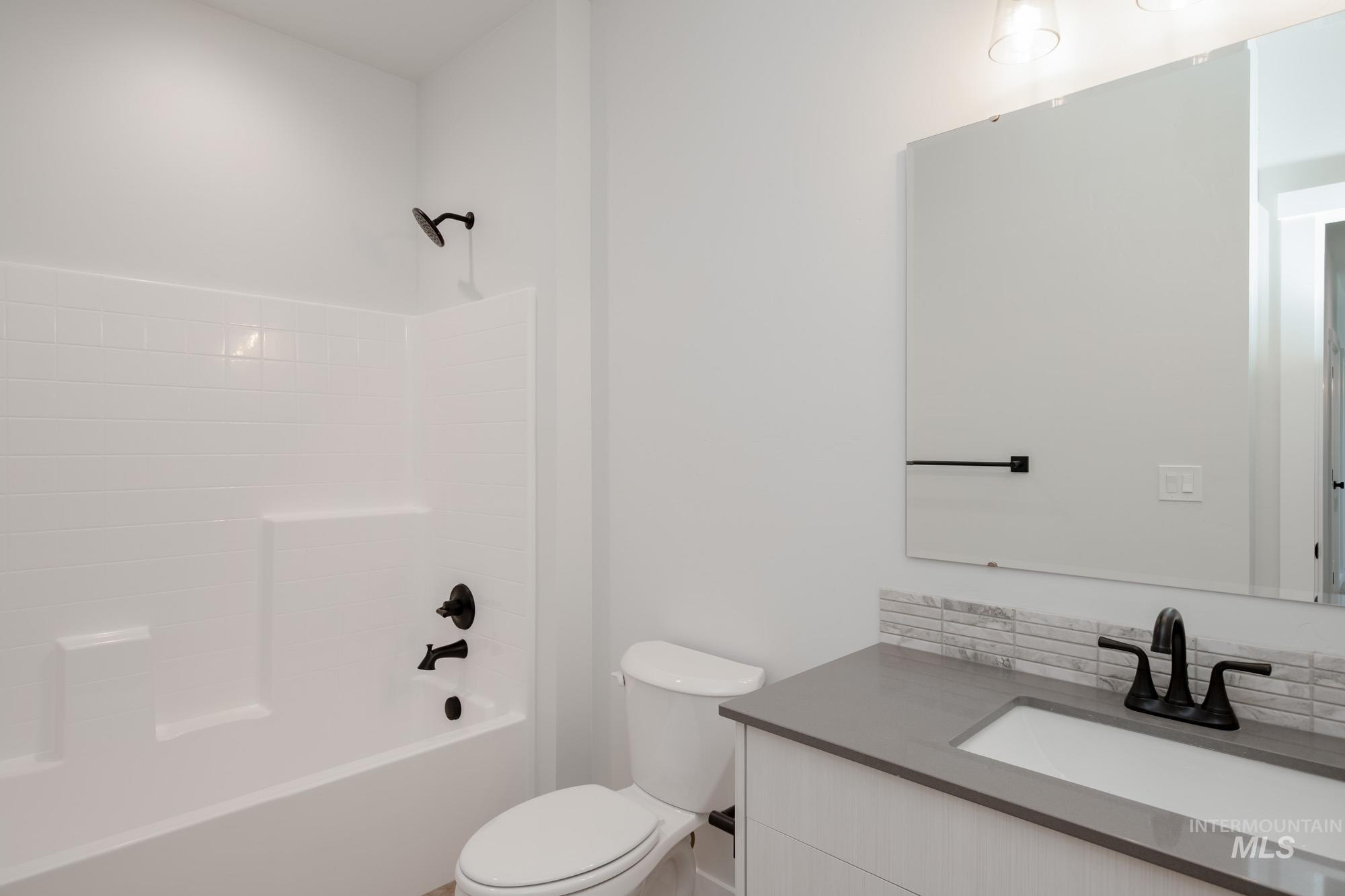 Bathroom featuring washtub / shower combination and vanity