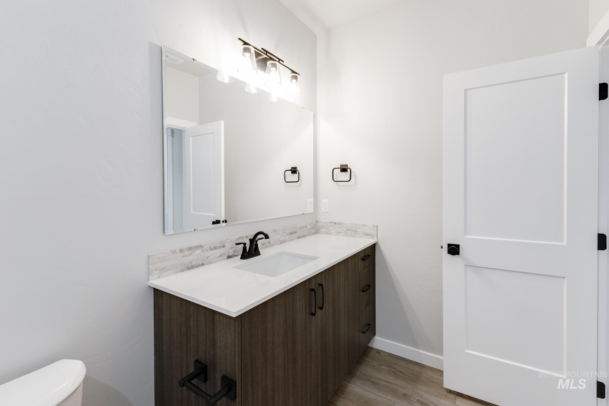Bathroom featuring vanity and light wood-style floors