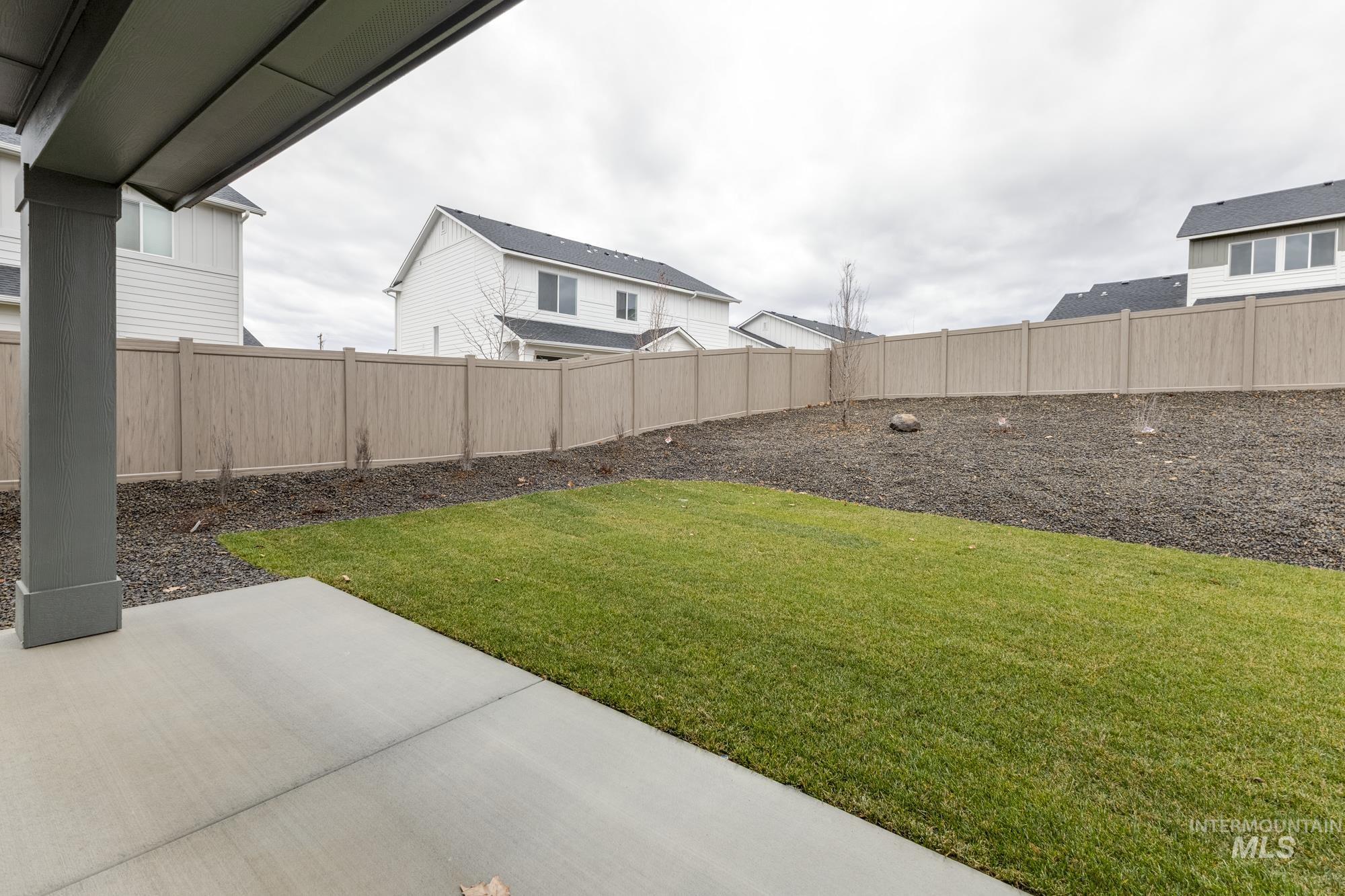 Fenced backyard with a patio