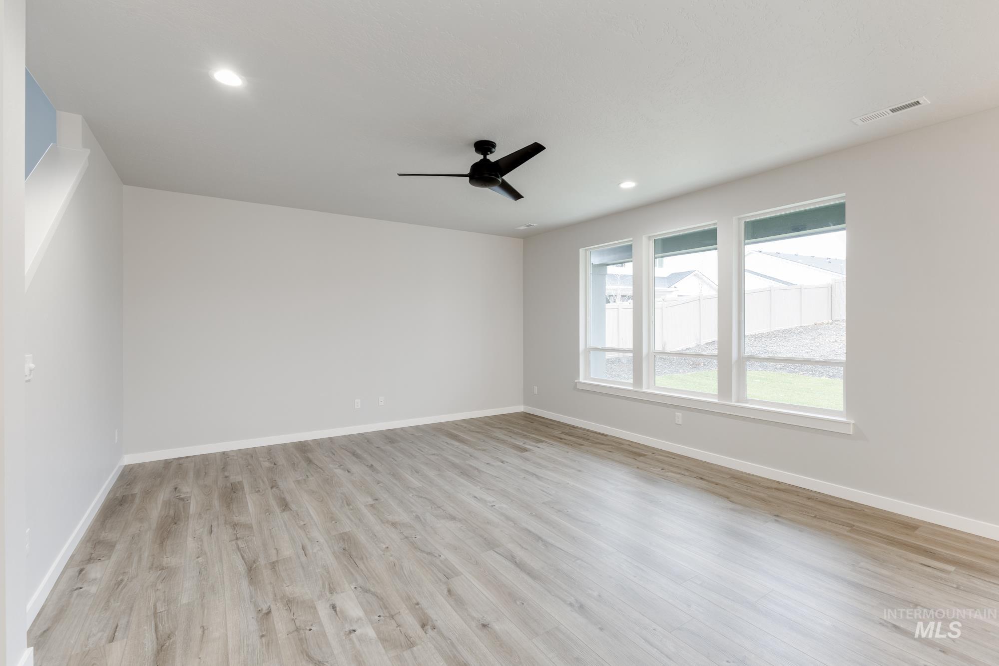 Spare room with light wood-style flooring, ceiling fan, and recessed lighting