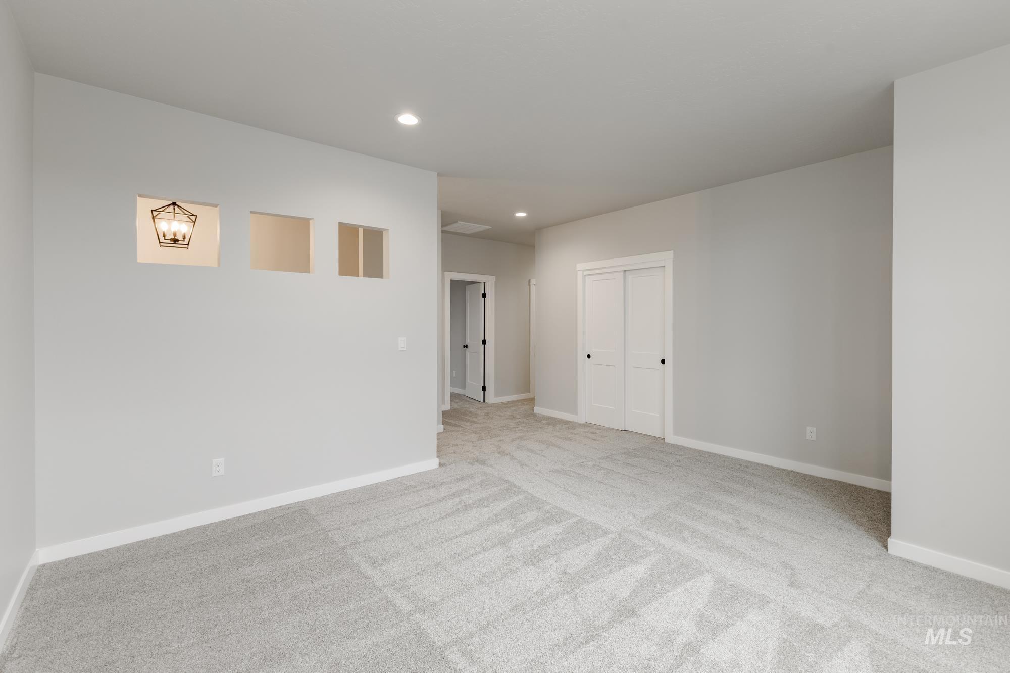 Unfurnished room with recessed lighting and light carpet