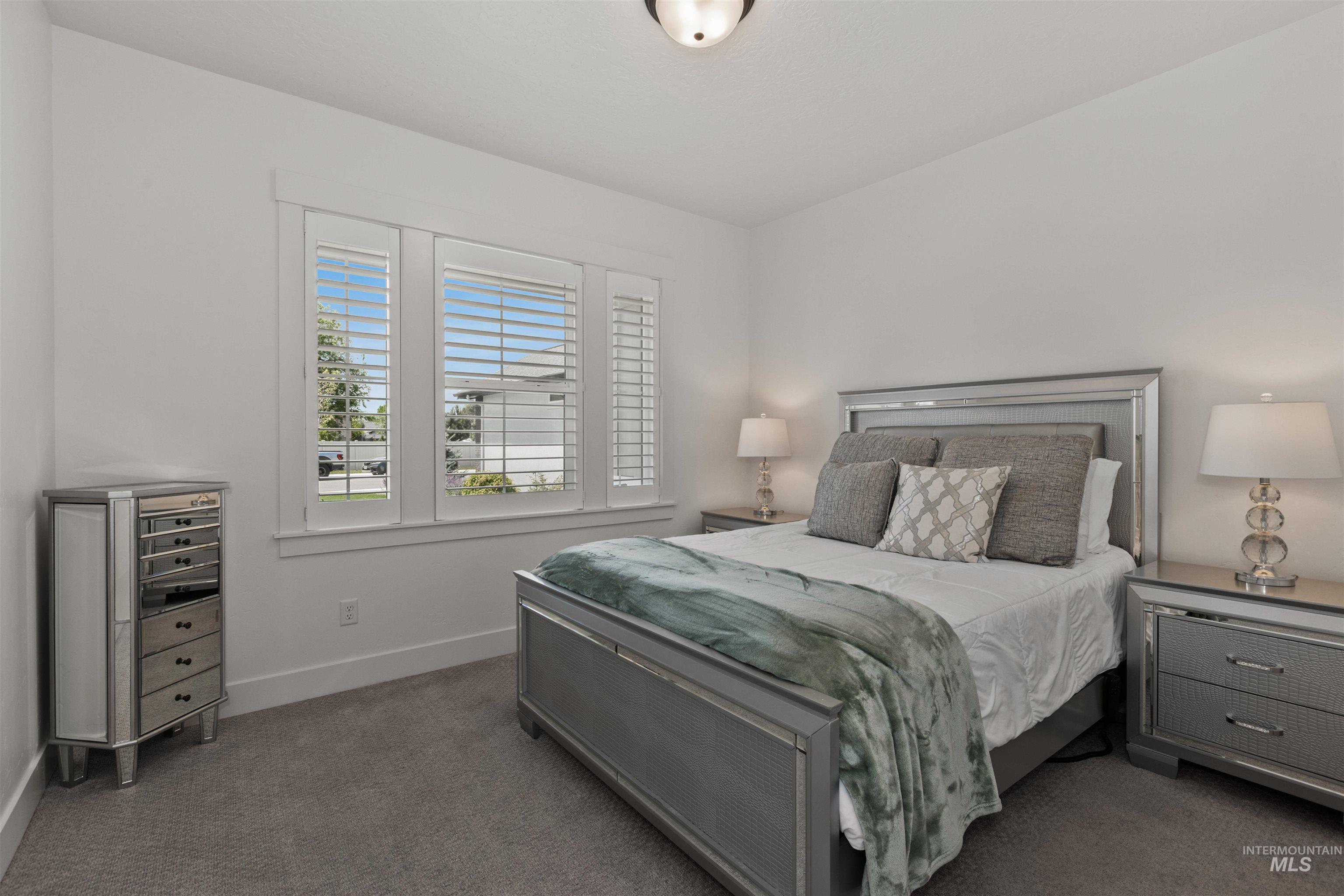 Bedroom featuring carpet flooring and baseboards