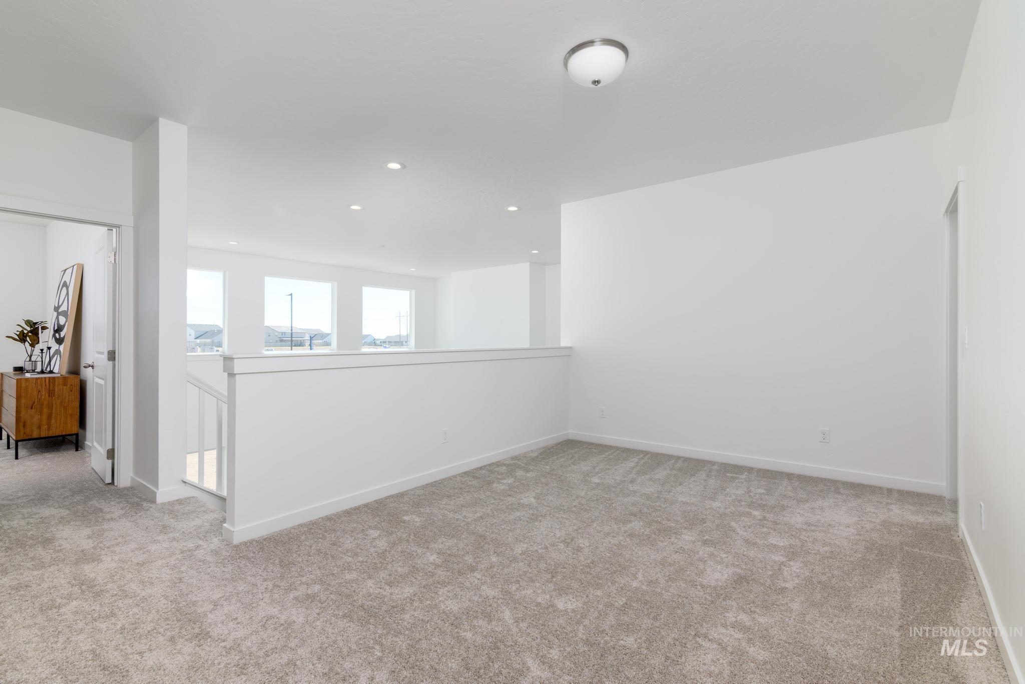 Unfurnished room featuring light colored carpet and recessed lighting