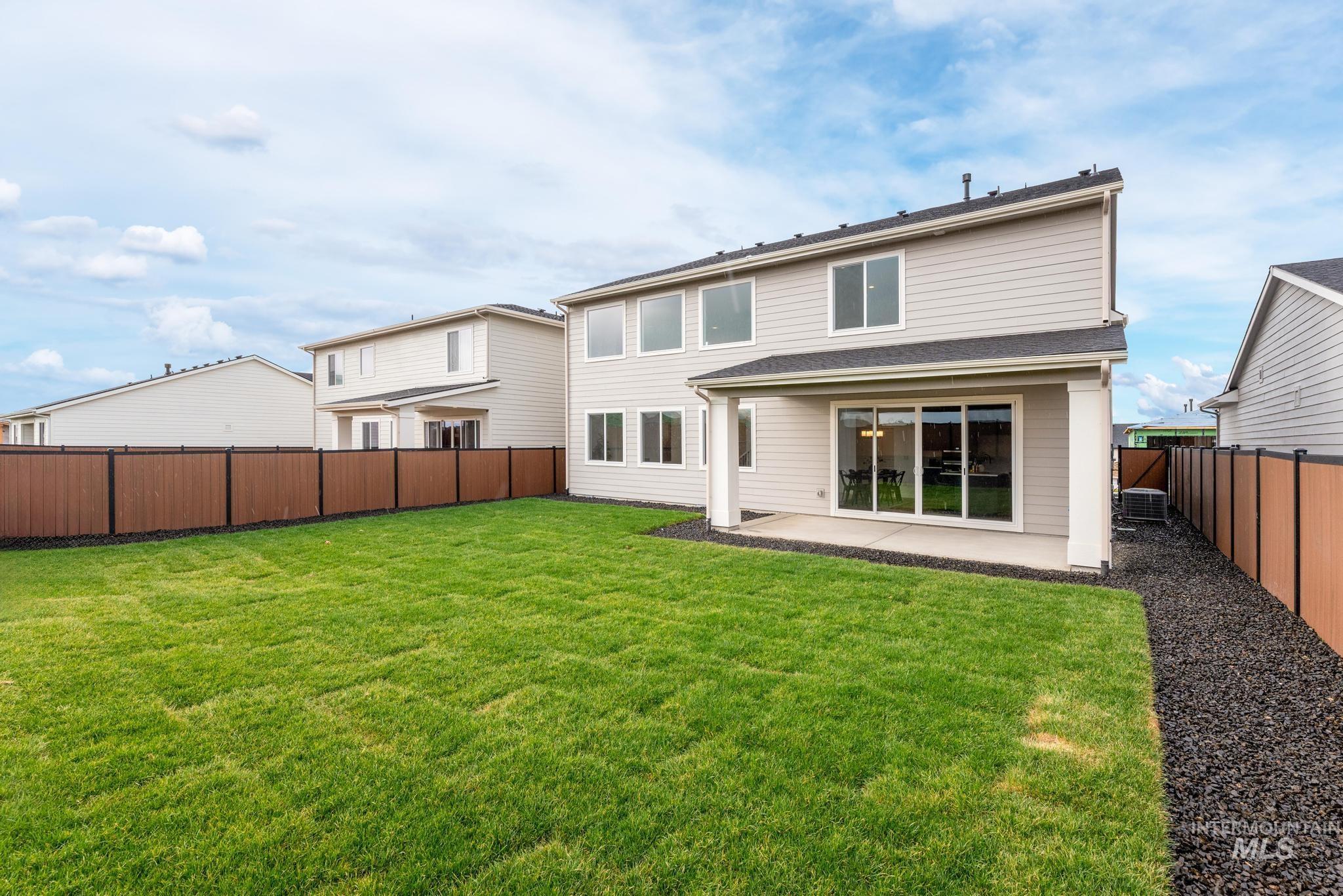 Rear view of house with a patio area and a fenced backyard