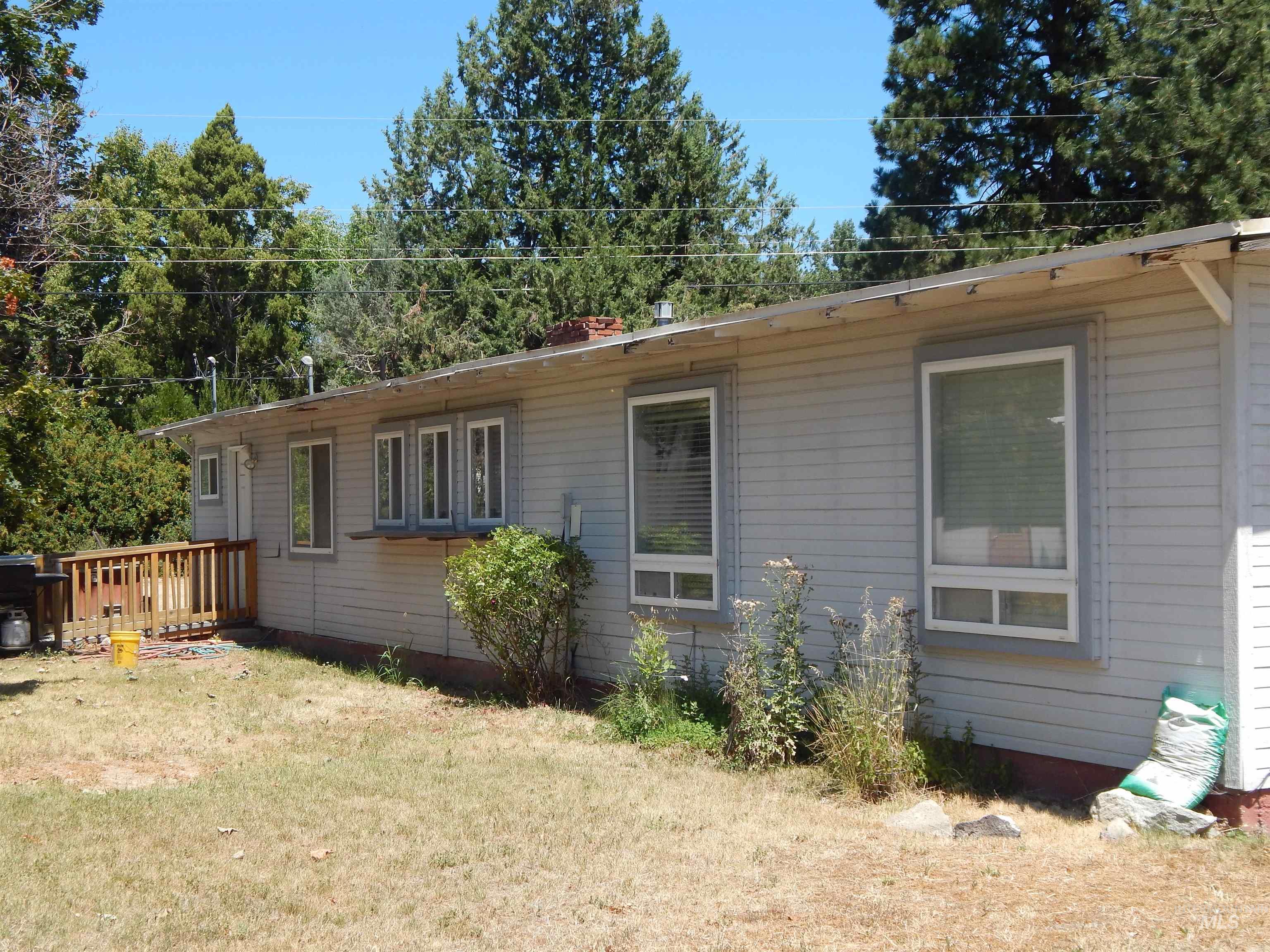 View of home's exterior featuring a yard and a deck