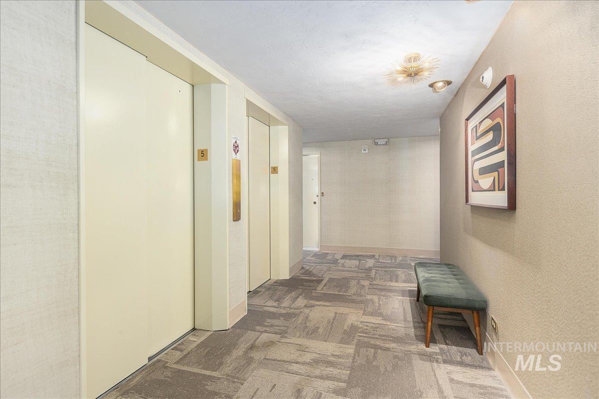 Hallway featuring elevator