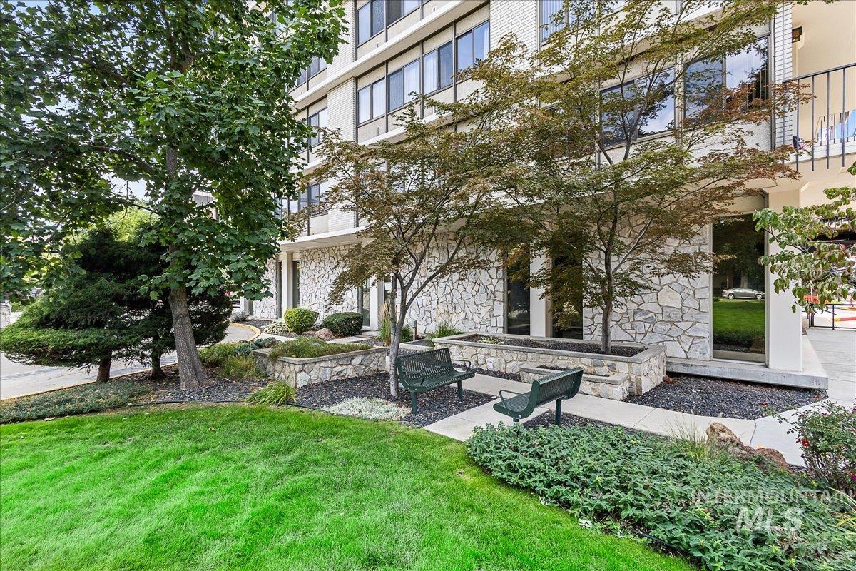 View of home's community with a lawn