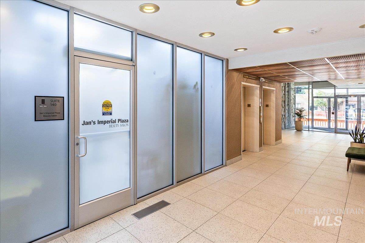 Lobby featuring a wall of windows and recessed lighting