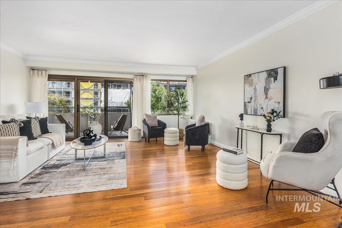 Living area featuring crown molding and wood finished floors