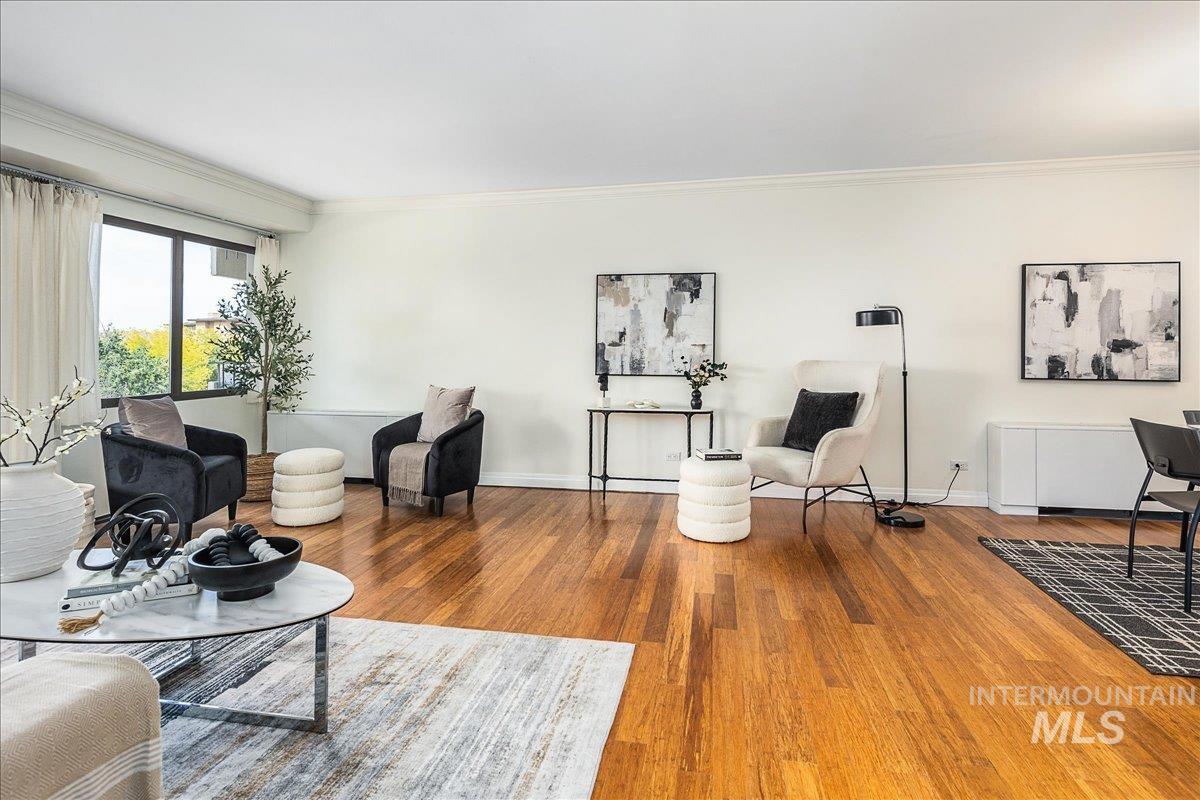 Living area featuring crown molding and wood finished floors