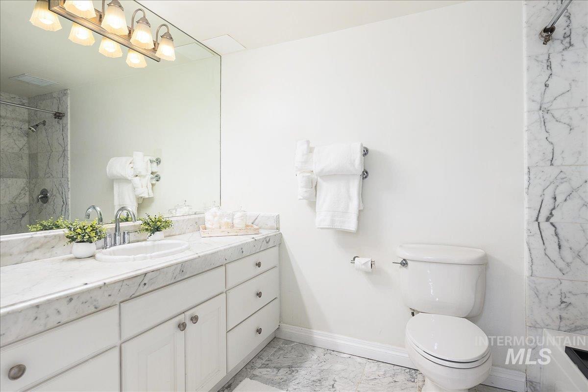 Full bath featuring vanity and toilet