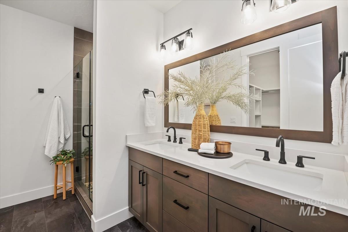 Bathroom with a shower stall and double vanity