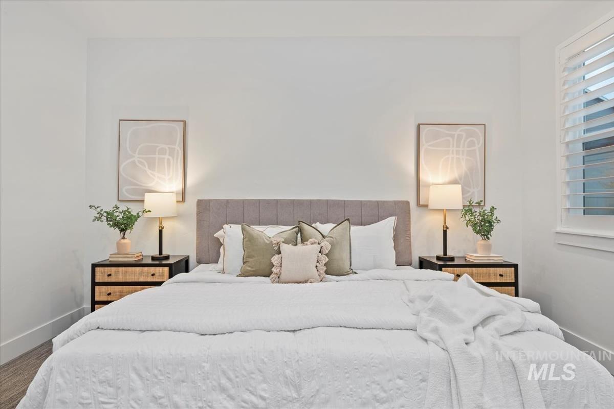 Bedroom with baseboards and wood finished floors