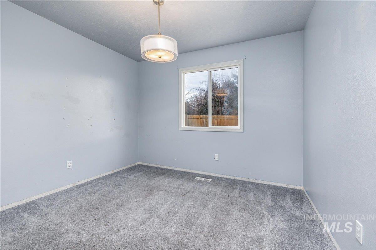 Bedroom featuring carpet and a textured ceiling