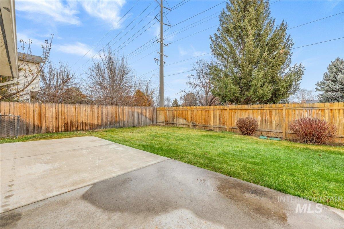 Fenced east-facing backyard featuring a large patio.