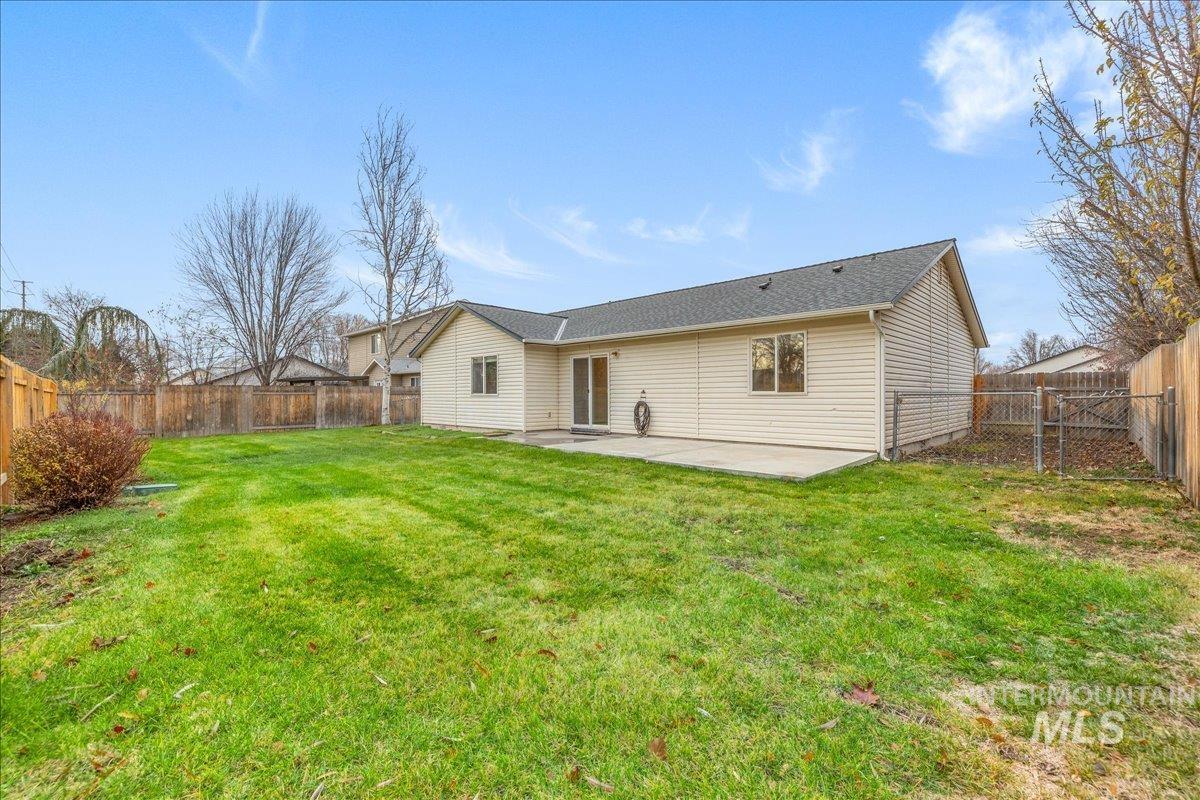 Rear view of property featuring a patio area and a fenced backyard