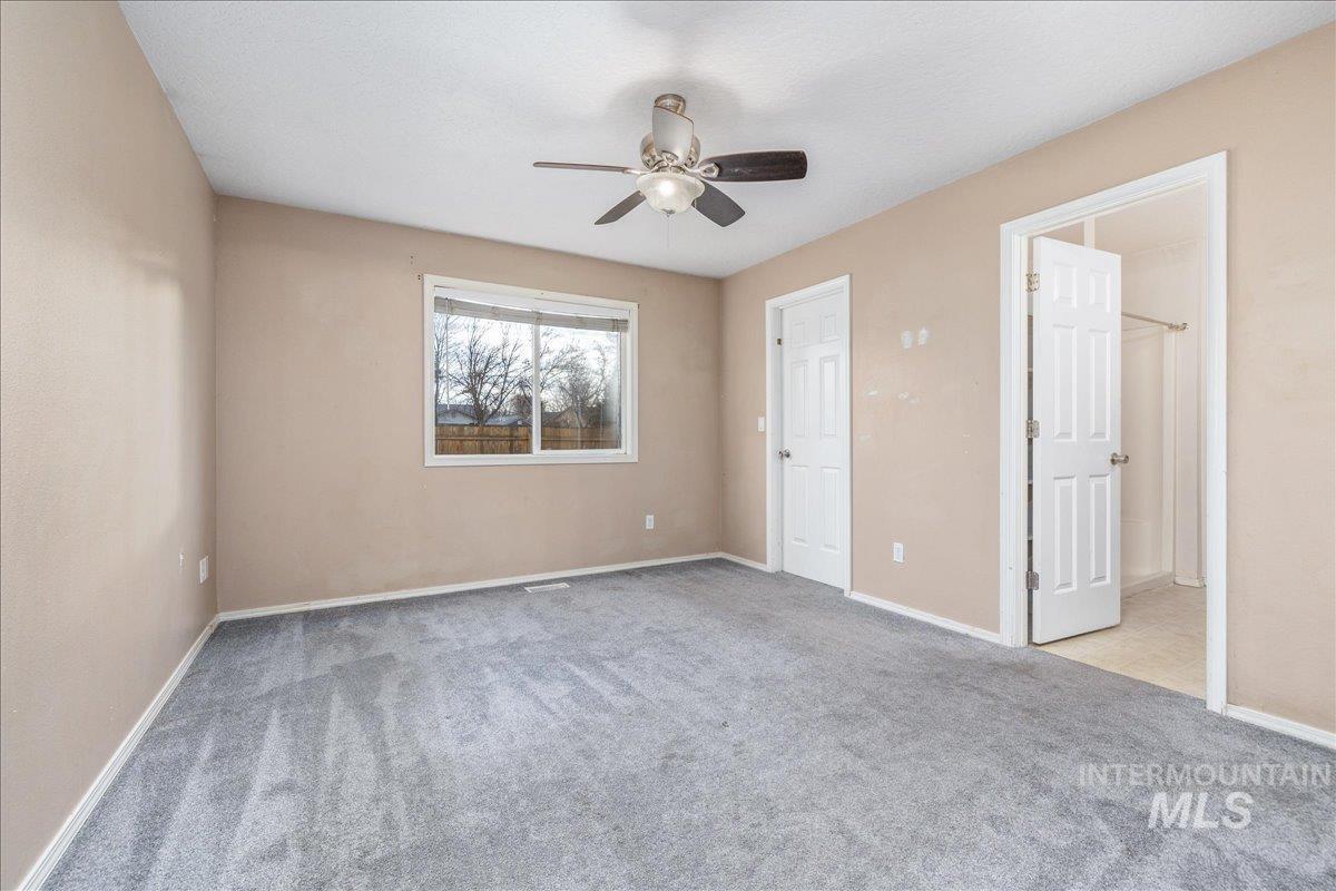 Unfurnished bedroom featuring light colored carpet and a ceiling fan
