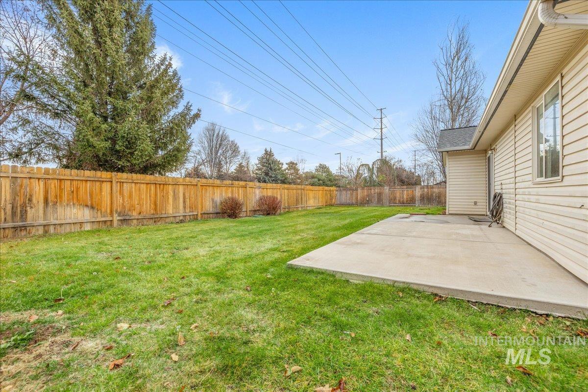 Fenced backyard with a patio area