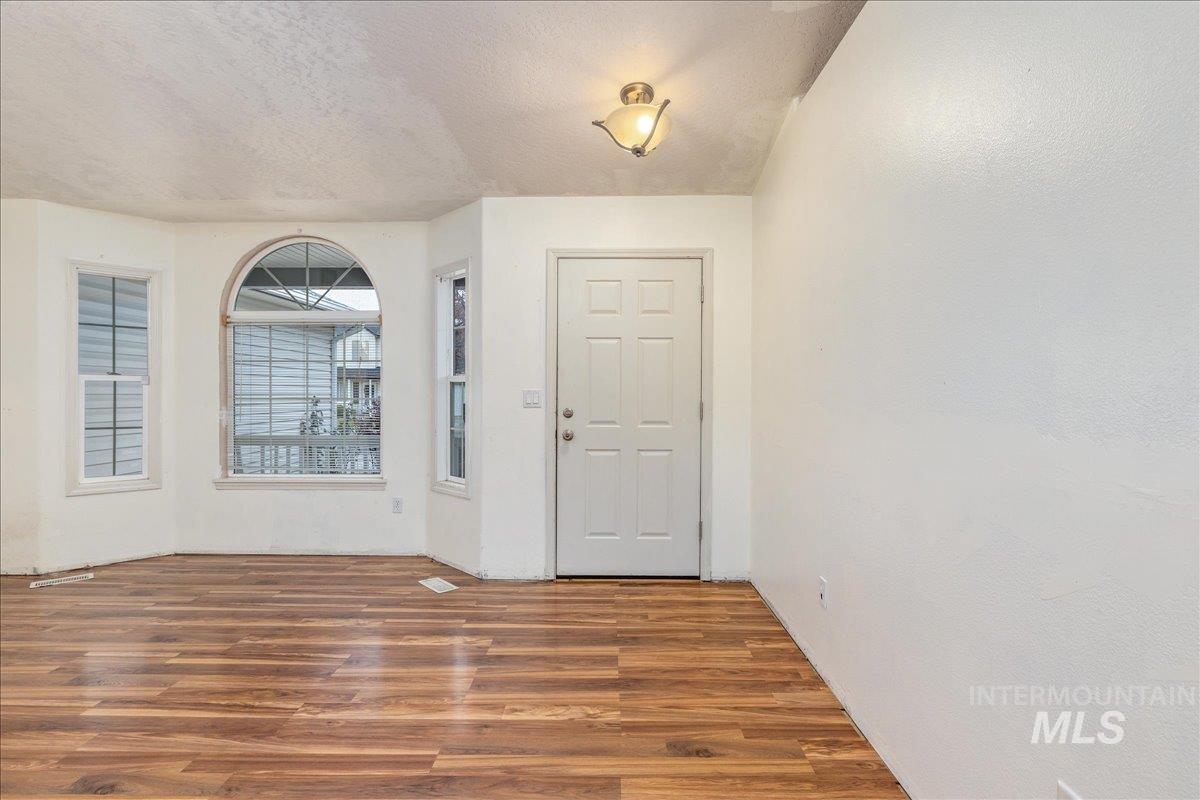 Entryway featuring a textured ceiling and wood finished floors
