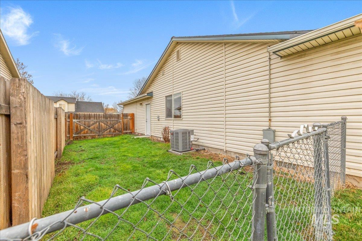 Fenced backyard with a gate.  Potential for RV parking.