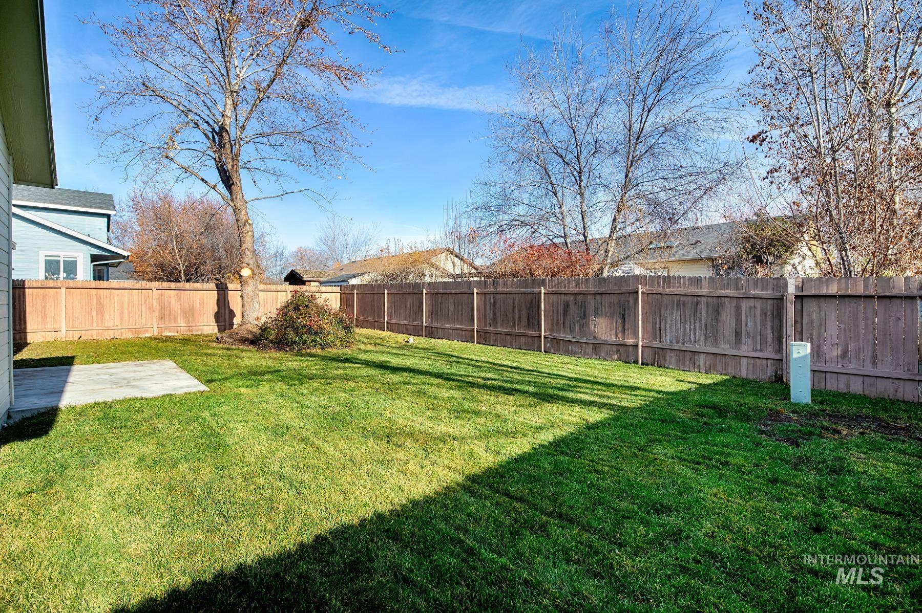 Fenced backyard with a patio area