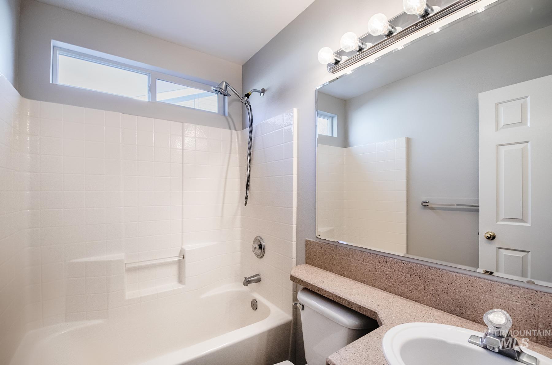 Full bath featuring vanity and bathtub / shower combination