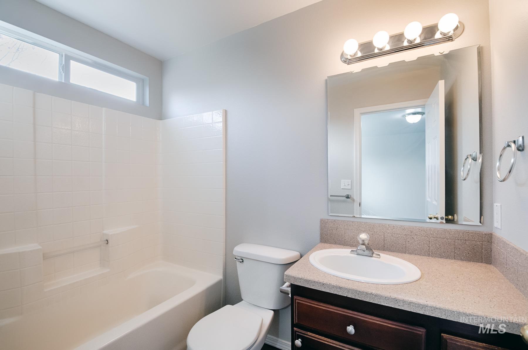 Bathroom with vanity and  shower combination